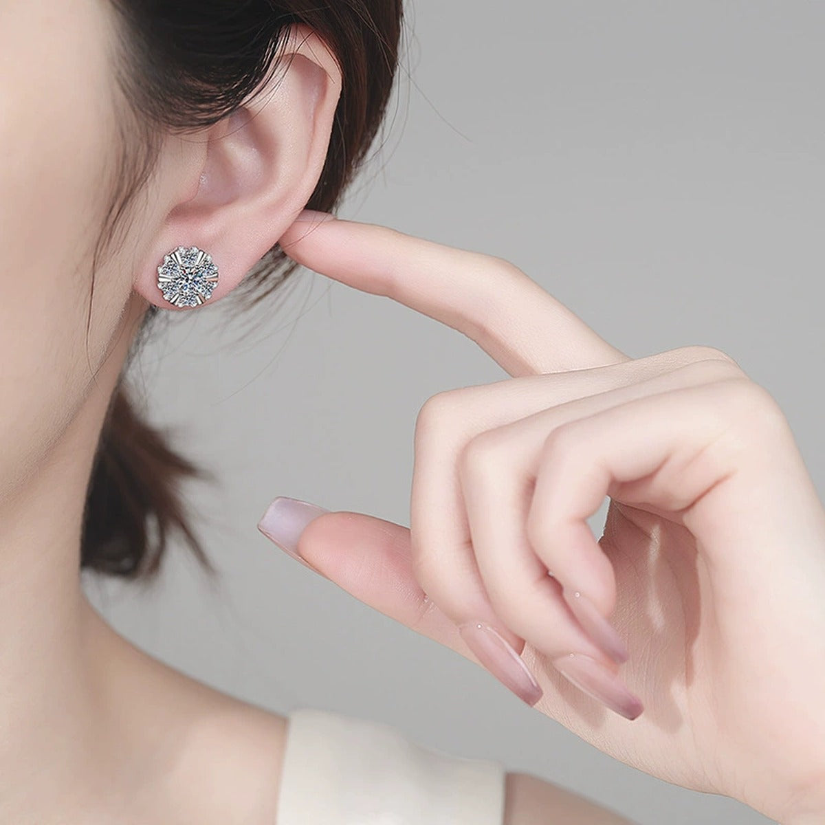 Starburst Moissanite Stud Earrings with CZ in Rhodium-Plated S925 sterling silver worn on ear by model showing scale, placement, and stud earrings styling