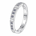 Round Moissanite Band Ring in rhodium-plated S925 sterling silver on clean white background