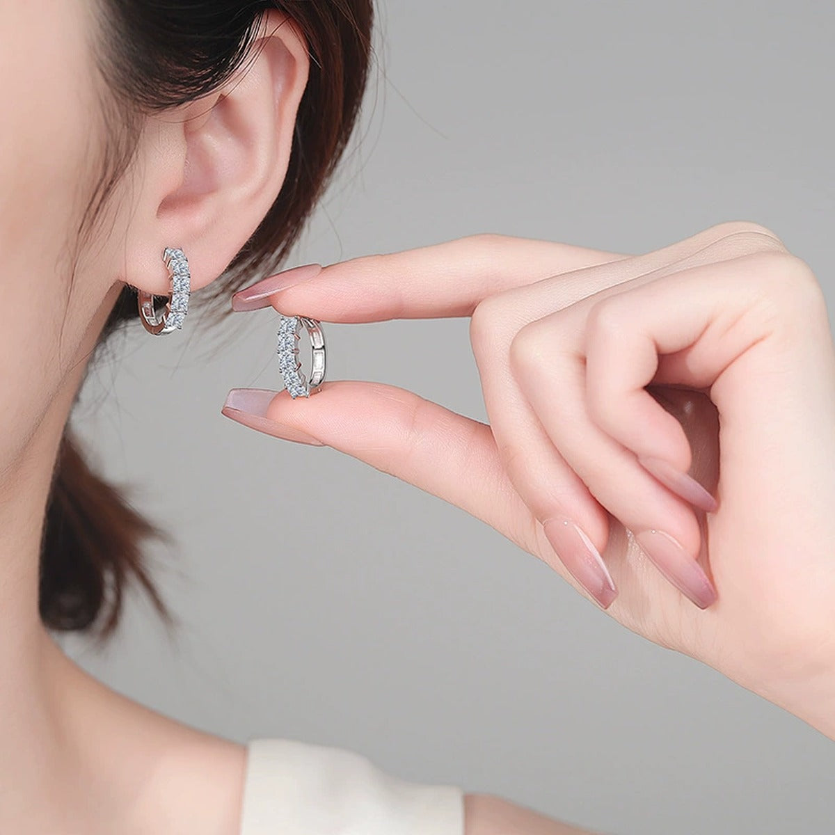 Princess Cut Moissanite Hoop Earrings in Rhodium-Plated S925 sterling silver worn on ear by model showing scale, placement, and hoop earrings styling