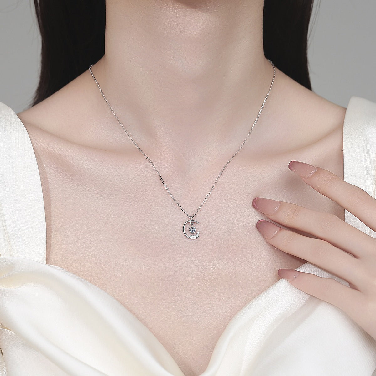 Dancing Moon Moissanite Pendant Necklace in Rhodium-Plated S925 sterling silver neckline model view showing pendant scale and adjustable chain
