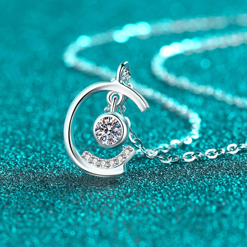 Dancing Moon Moissanite Pendant Necklace in Rhodium-Plated S925 sterling silver blue display scene showing chain and stone layout