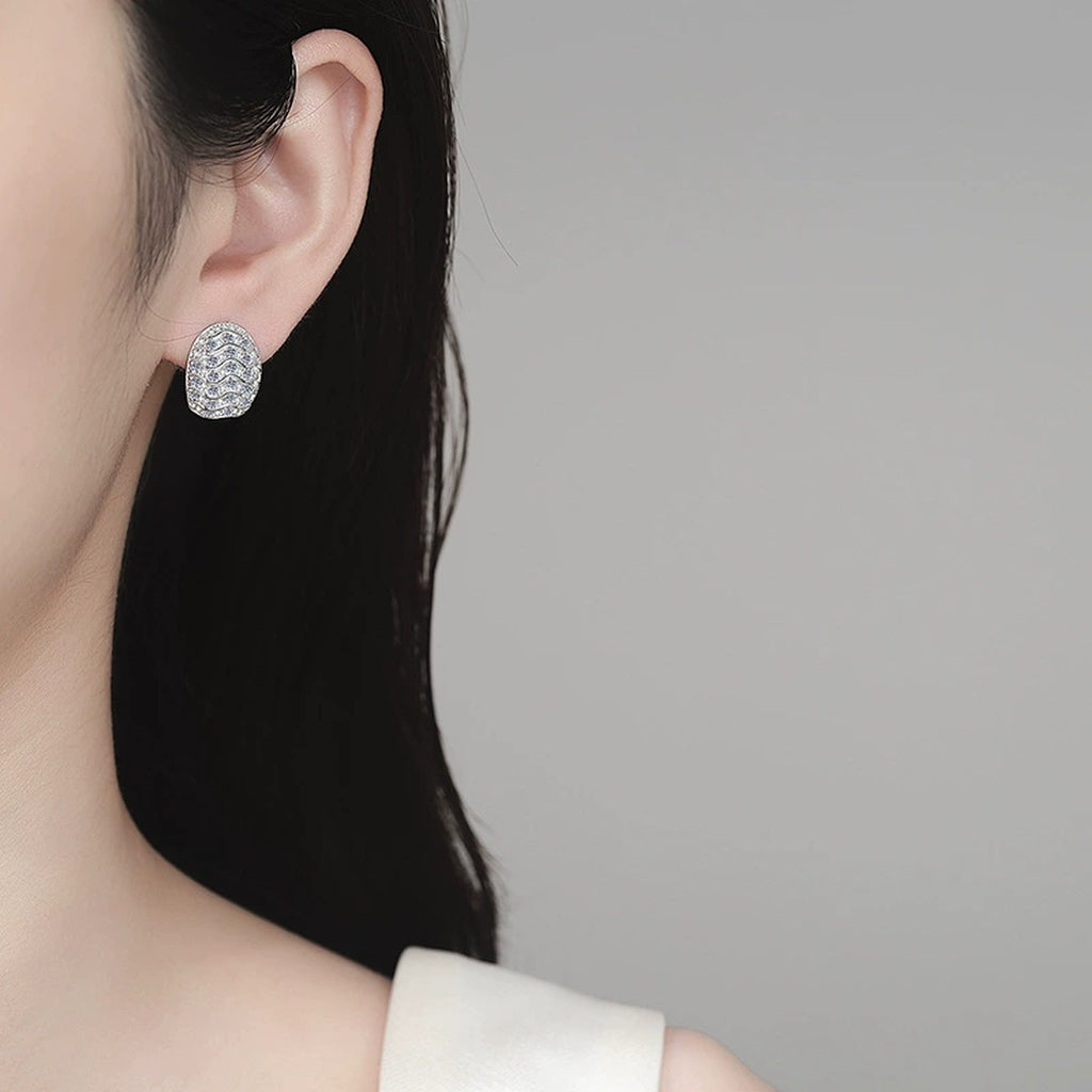 Wave Pave Moissanite Huggie Hoop Earrings in Rhodium-Plated S925 sterling silver worn on ear by model showing scale, placement, and huggie hoop earrings styling