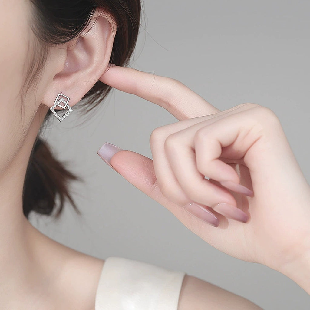 Geometric Moissanite Stud Drop Earrings in Rhodium-Plated S925 sterling silver worn on ear by model showing scale, placement, and stud earrings styling
