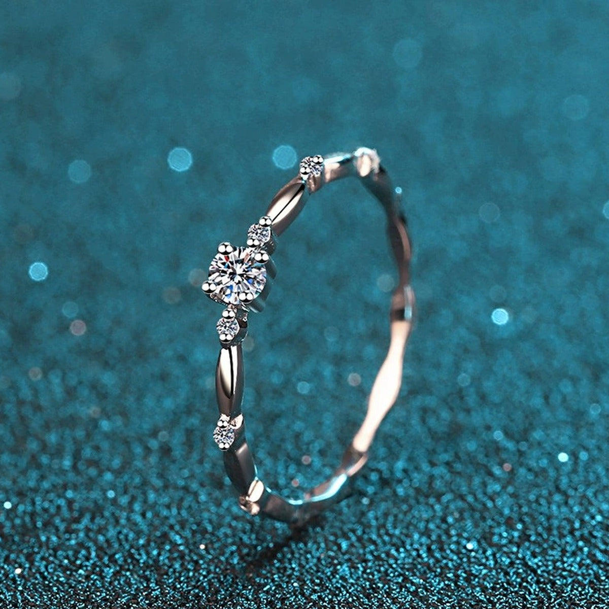 Twist Moissanite Band Ring with CZ in Rhodium-Plated S925 Sterling Silver blue display product photo showing the moissanite setting and band profile
