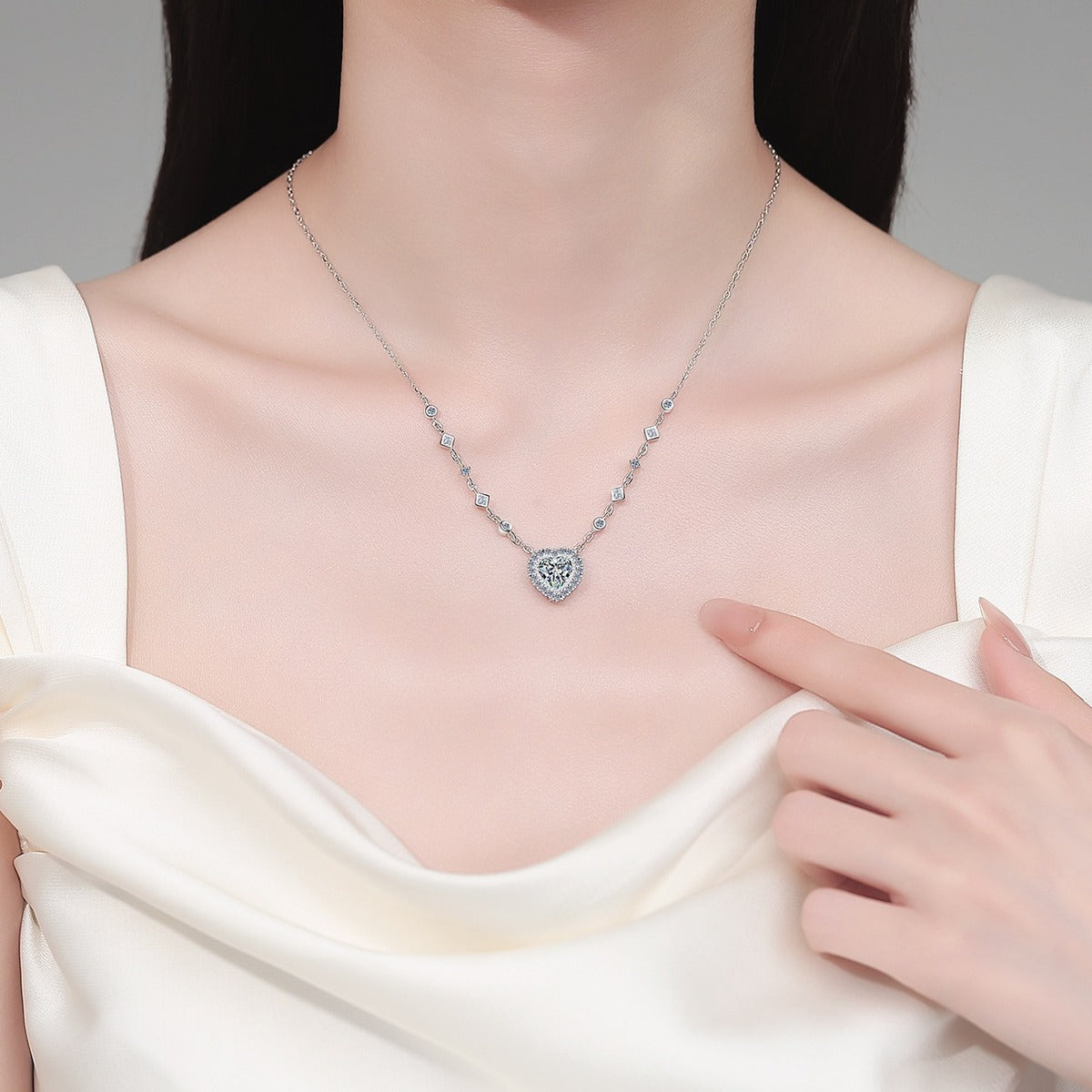 Heart Halo Moissanite Station Necklace with CZ in Rhodium-Plated S925 sterling silver neckline model view showing pendant scale and adjustable chain