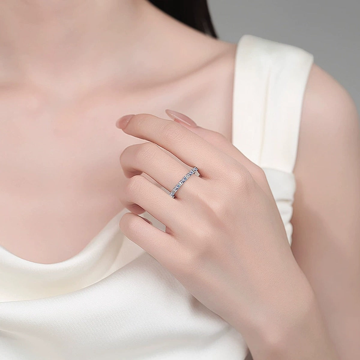 Emerald Cut Moissanite Band Ring worn on hand to show scale, band width, and ring profile