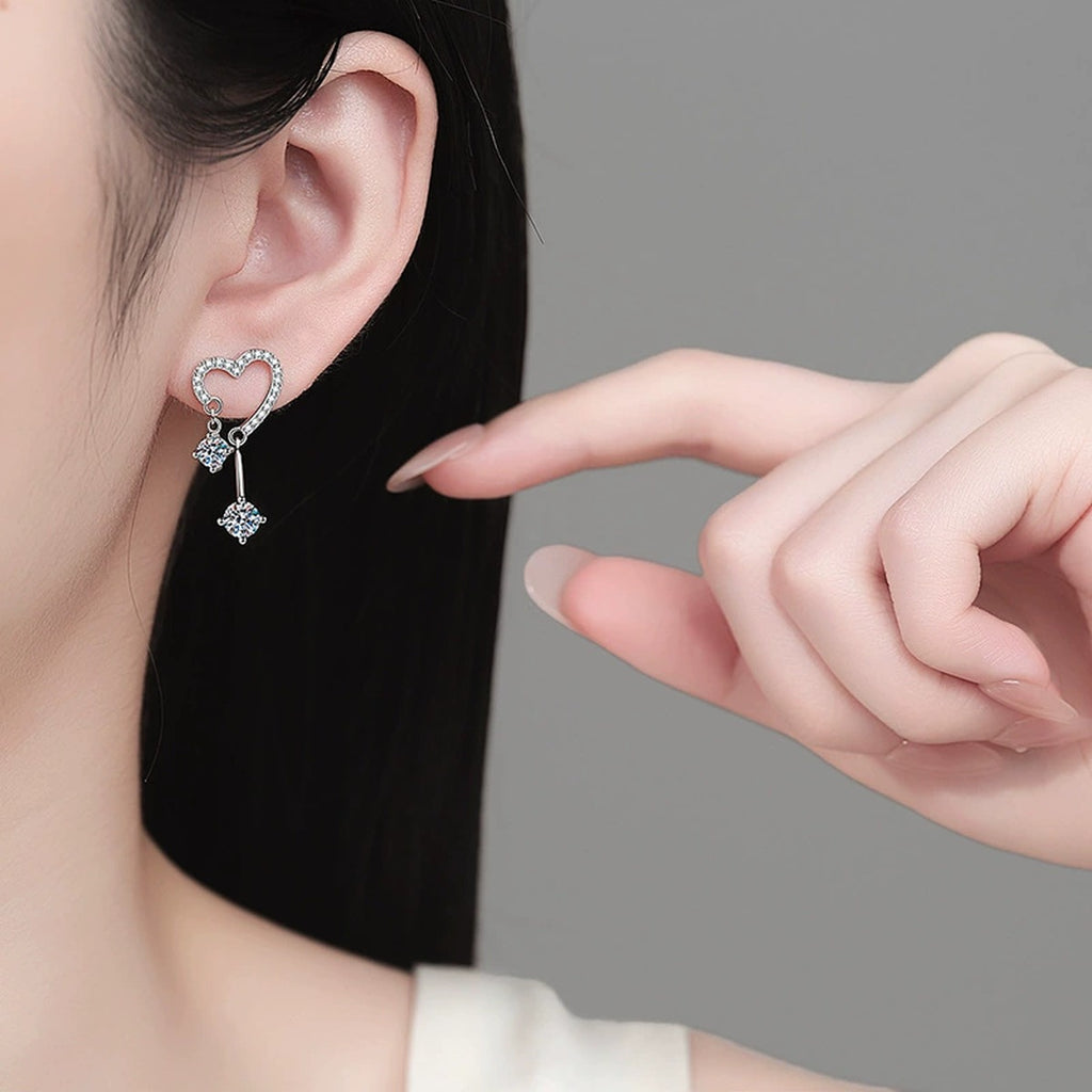 Heart Moissanite Stud Dangle Earrings with CZ in Rhodium-Plated S925 sterling silver worn on ear by model showing scale, placement, and stud dangle earrings styling