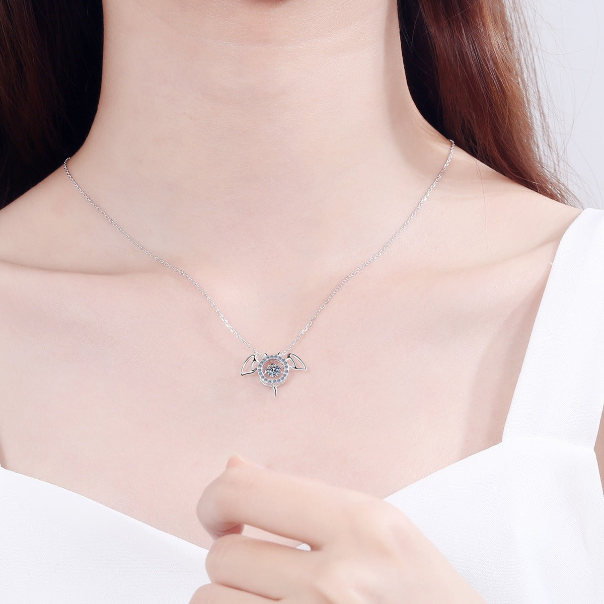 Devil Wing Moissanite Pendant Necklace with CZ in Rhodium-Plated S925 sterling silver worn on neckline by model showing scale and adjustable chain styling