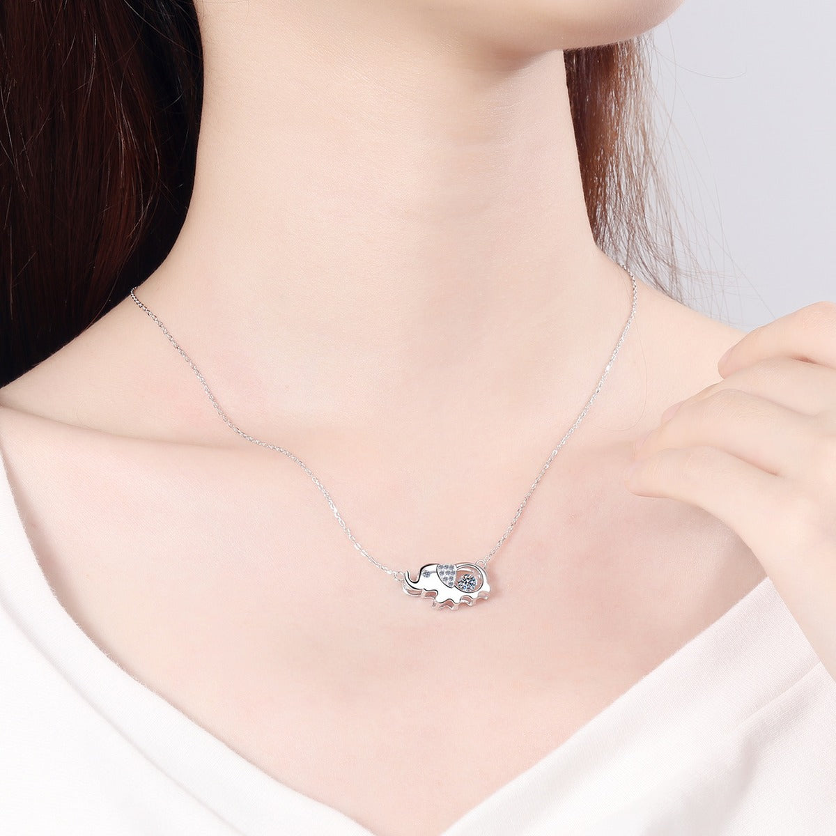 Elephant Moissanite Pendant Necklace with CZ in Rhodium-Plated S925 sterling silver worn on neckline by model showing scale and adjustable chain styling