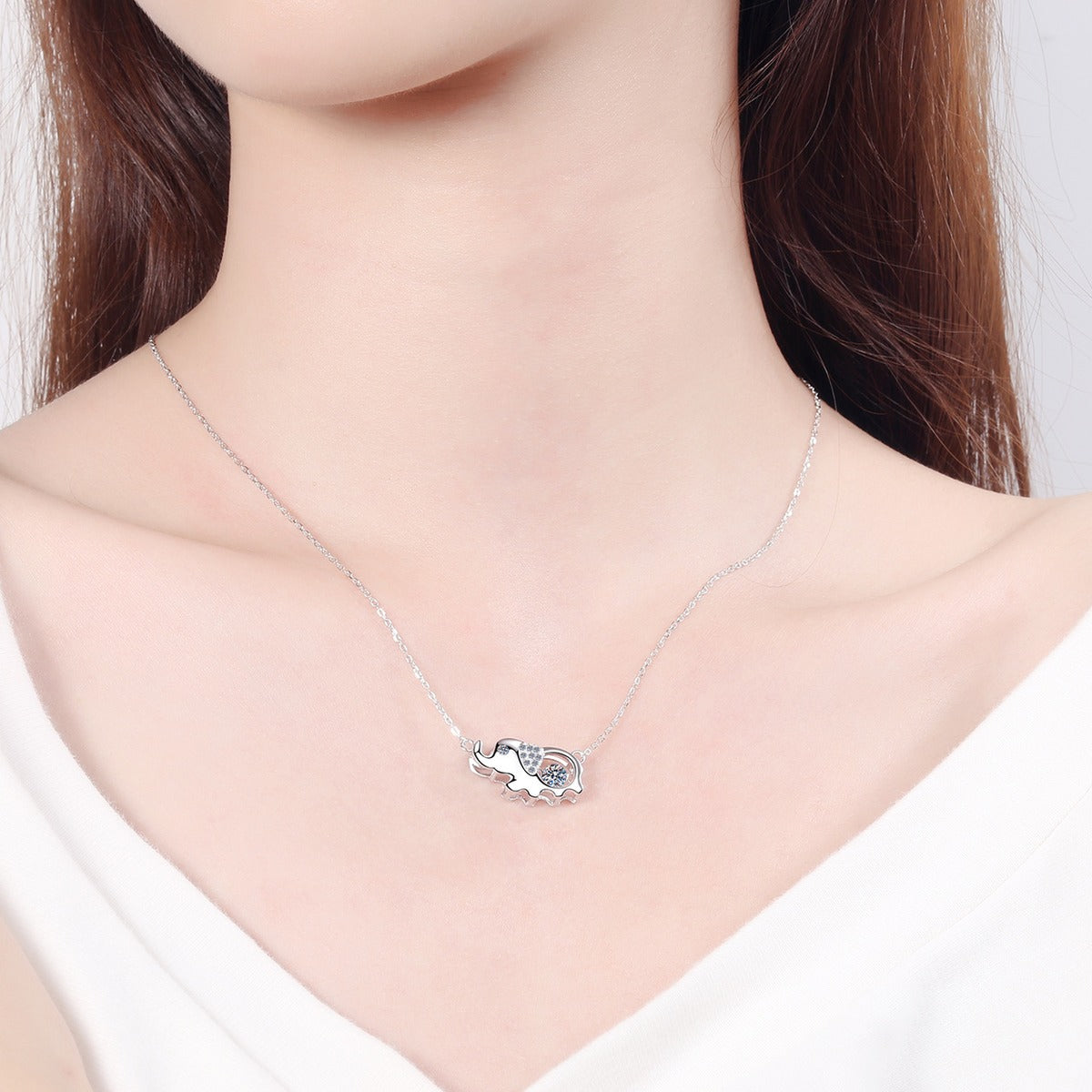 Elephant Moissanite Pendant Necklace with CZ in Rhodium-Plated S925 sterling silver worn on neckline by model showing scale and adjustable chain styling