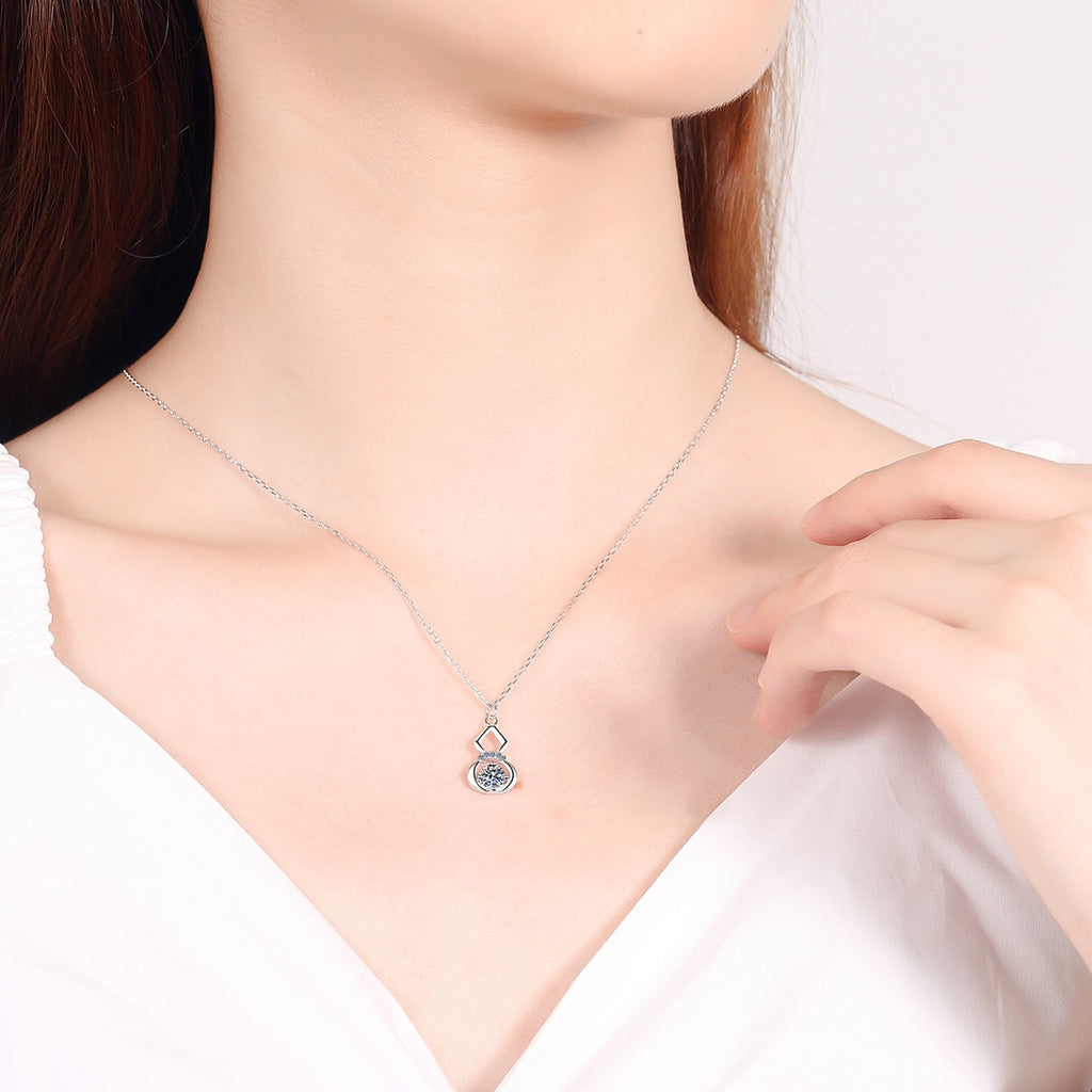 Gourd Moissanite Pendant Necklace with CZ in Rhodium-Plated S925 sterling silver worn on neckline by model showing scale and adjustable chain styling