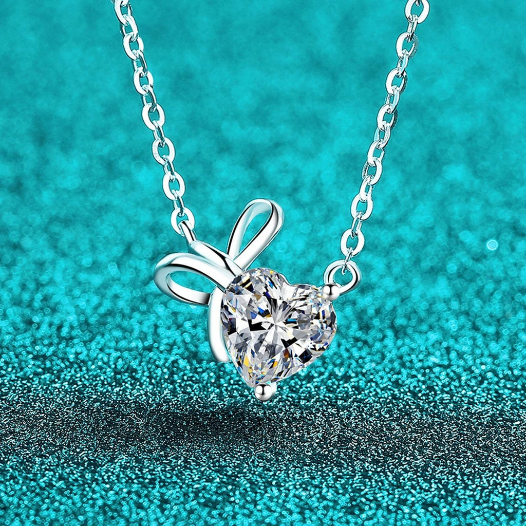 Bow Heart Moissanite Pendant Necklace in Rhodium-Plated S925 sterling silver blue display scene showing chain and stone layout