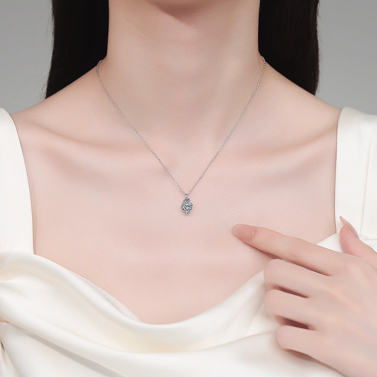 Bow Heart and Round Moissanite Pendant Necklace in Rhodium-Plated S925 sterling silver neckline model view showing pendant scale and adjustable chain