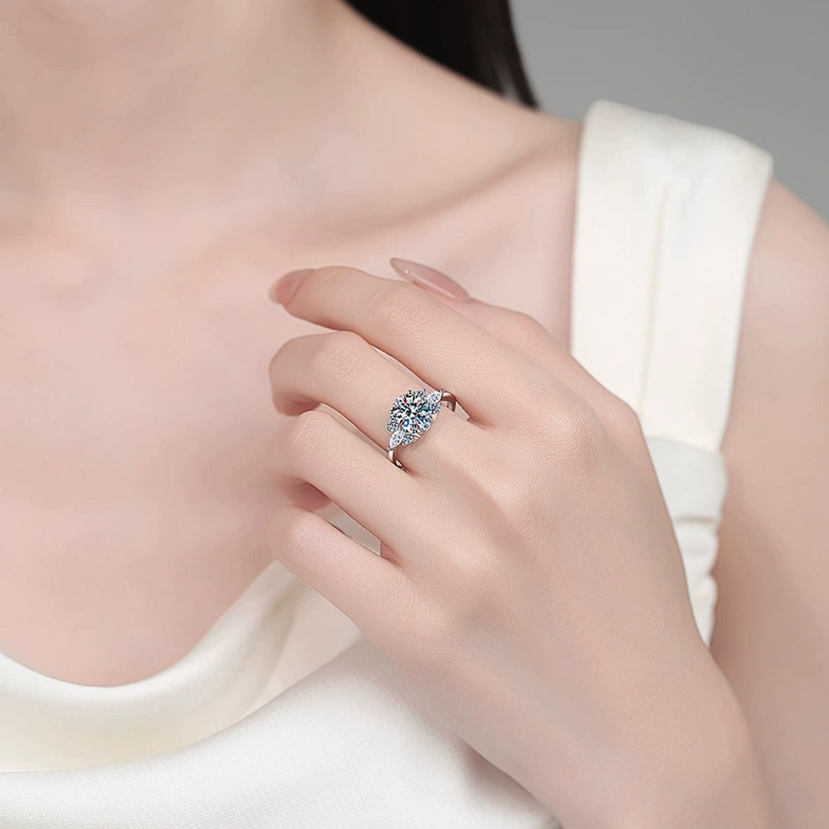 Oval Moissanite Engagement Ring with CZ worn on hand to show scale, band width, and ring profile