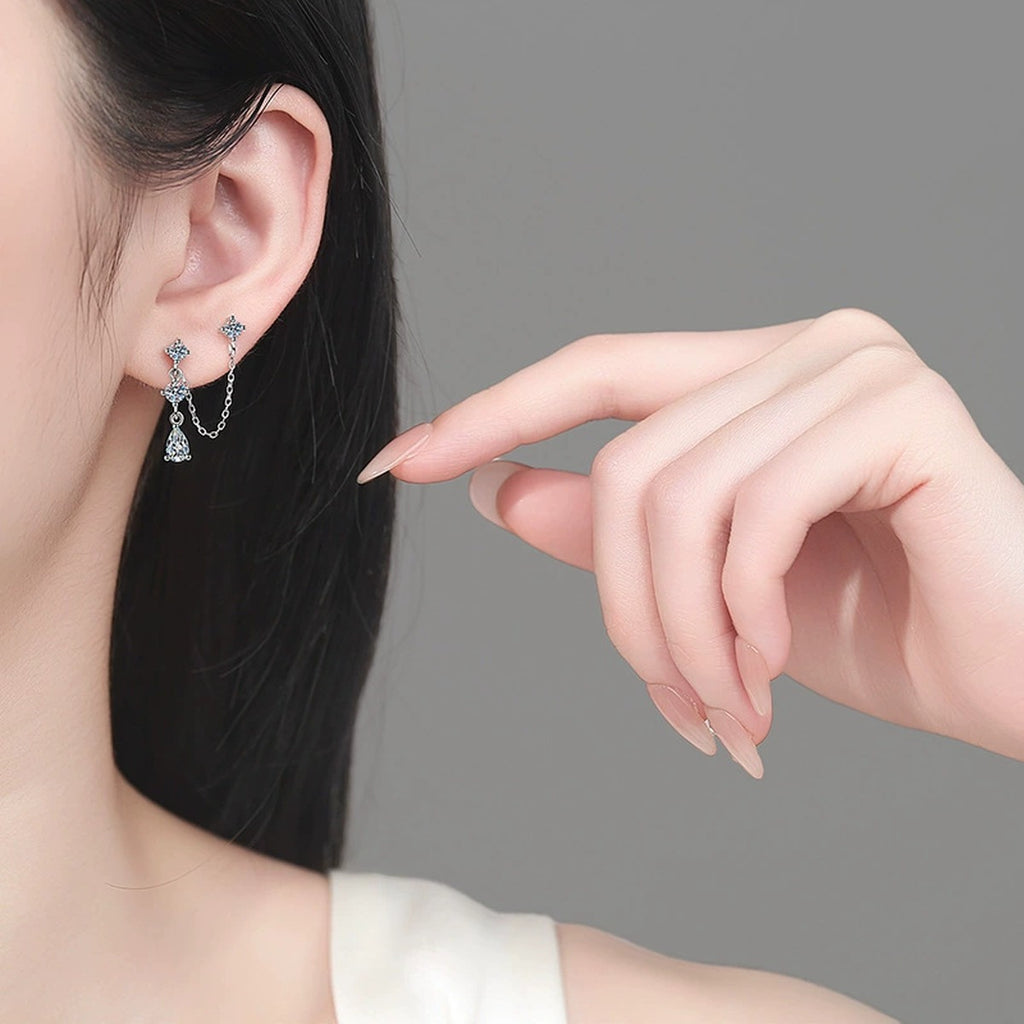Star Moissanite Stud Dangle Earrings in Rhodium-Plated S925 sterling silver worn on ear by model showing scale, placement, and stud dangle earrings styling