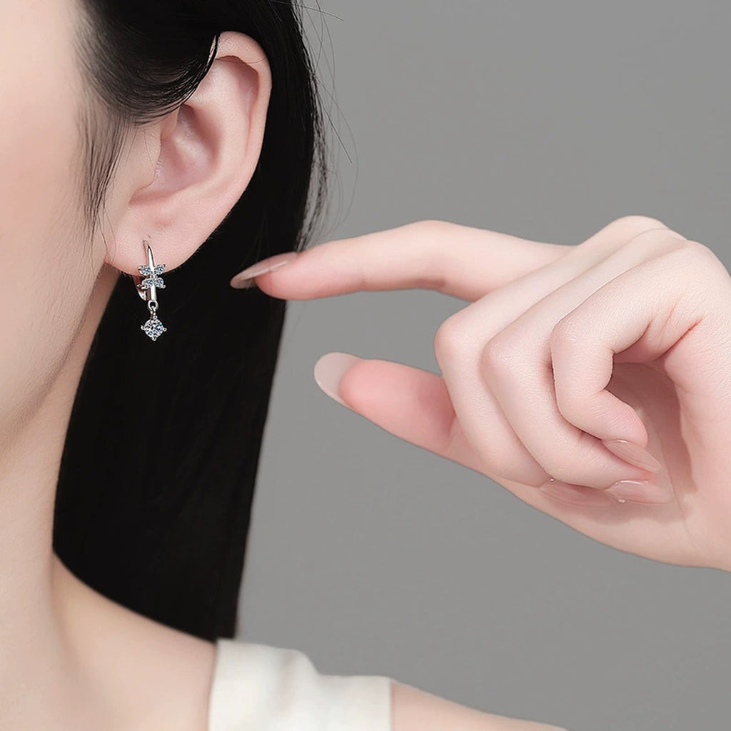 Star Moissanite Hook Dangle Earrings in Rhodium-Plated S925 sterling silver worn on ear by model showing scale, placement, and hook dangle earrings styling