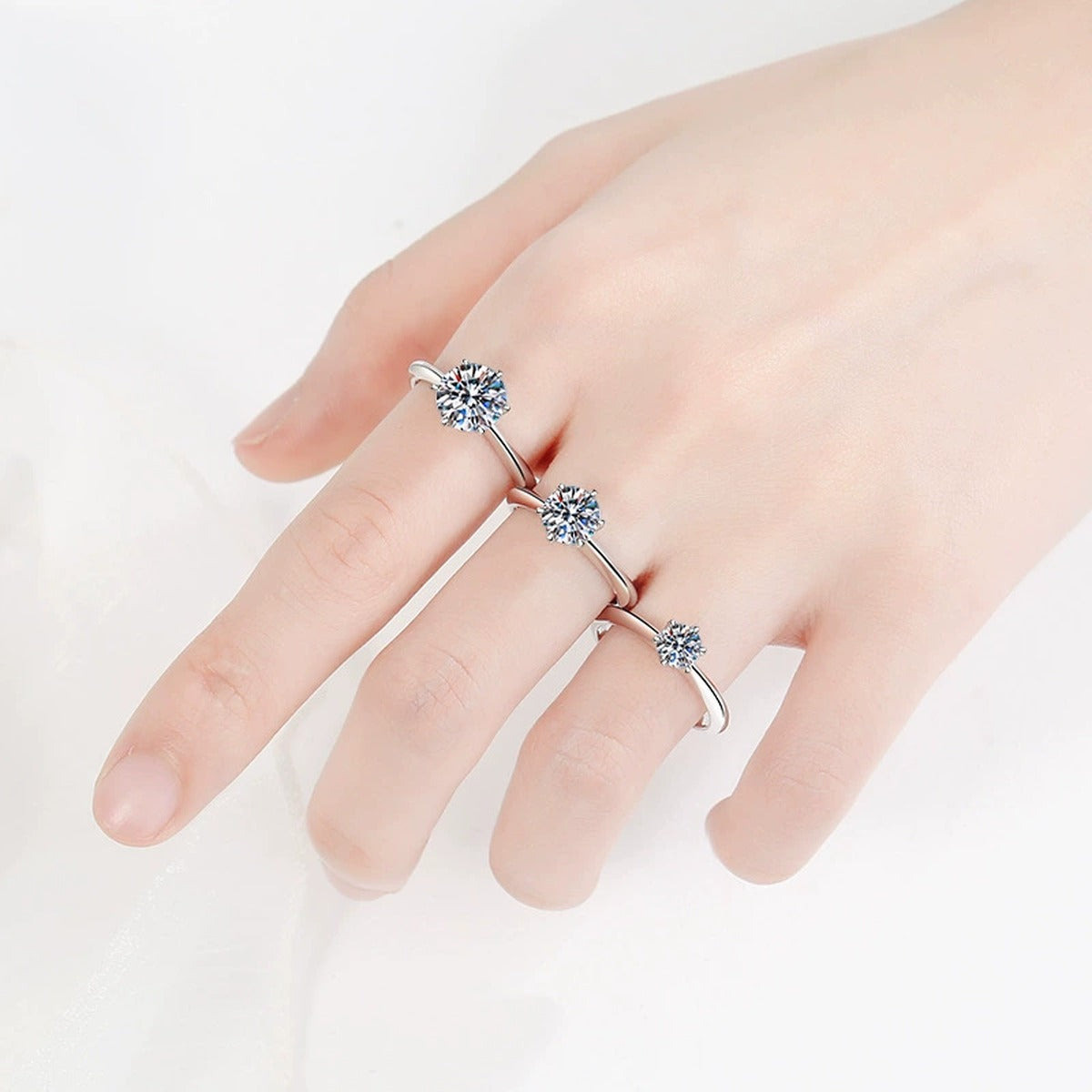 Round Moissanite Solitaire Ring in Rhodium-Plated S925 Sterling Silver worn on hand, showing scale, finger coverage, and rhodium-plated finish