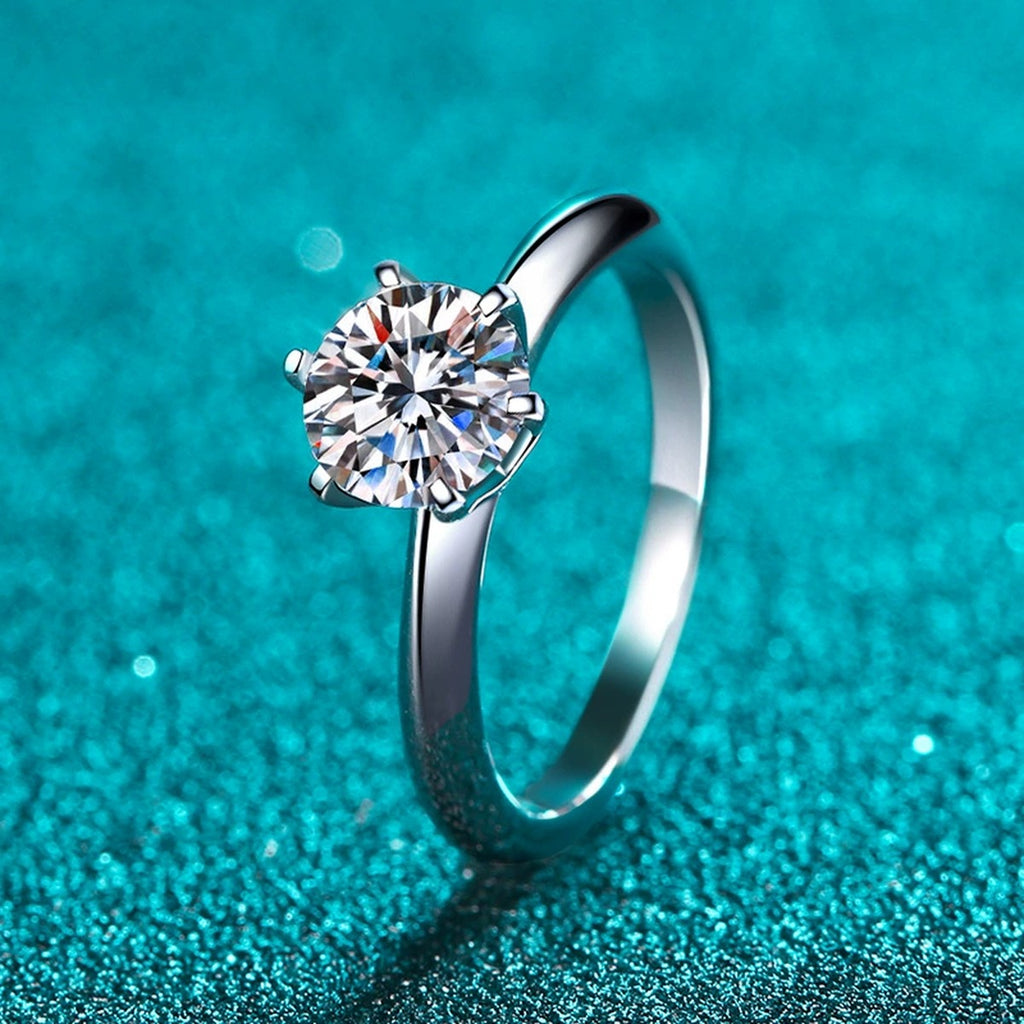 Round Moissanite Solitaire Ring in Rhodium-Plated S925 Sterling Silver blue display product photo showing the moissanite setting and band profile