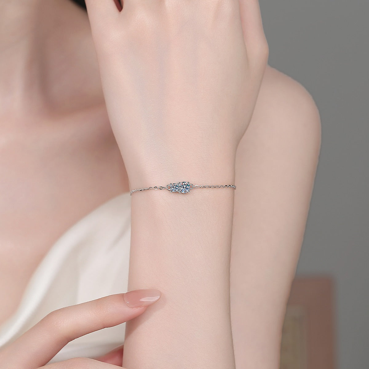 Round Moissanite Adjustable Chain Bracelet in Rhodium-Plated S925 sterling silver worn on wrist model view showing scale and adjustable fit