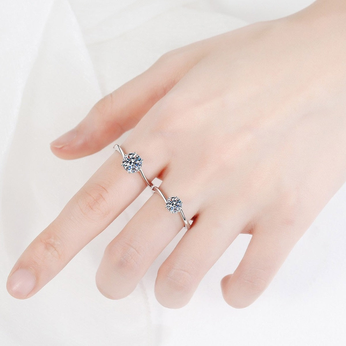 Round Moissanite Solitaire Engagement Ring worn on hand to show scale, band width, and ring profile