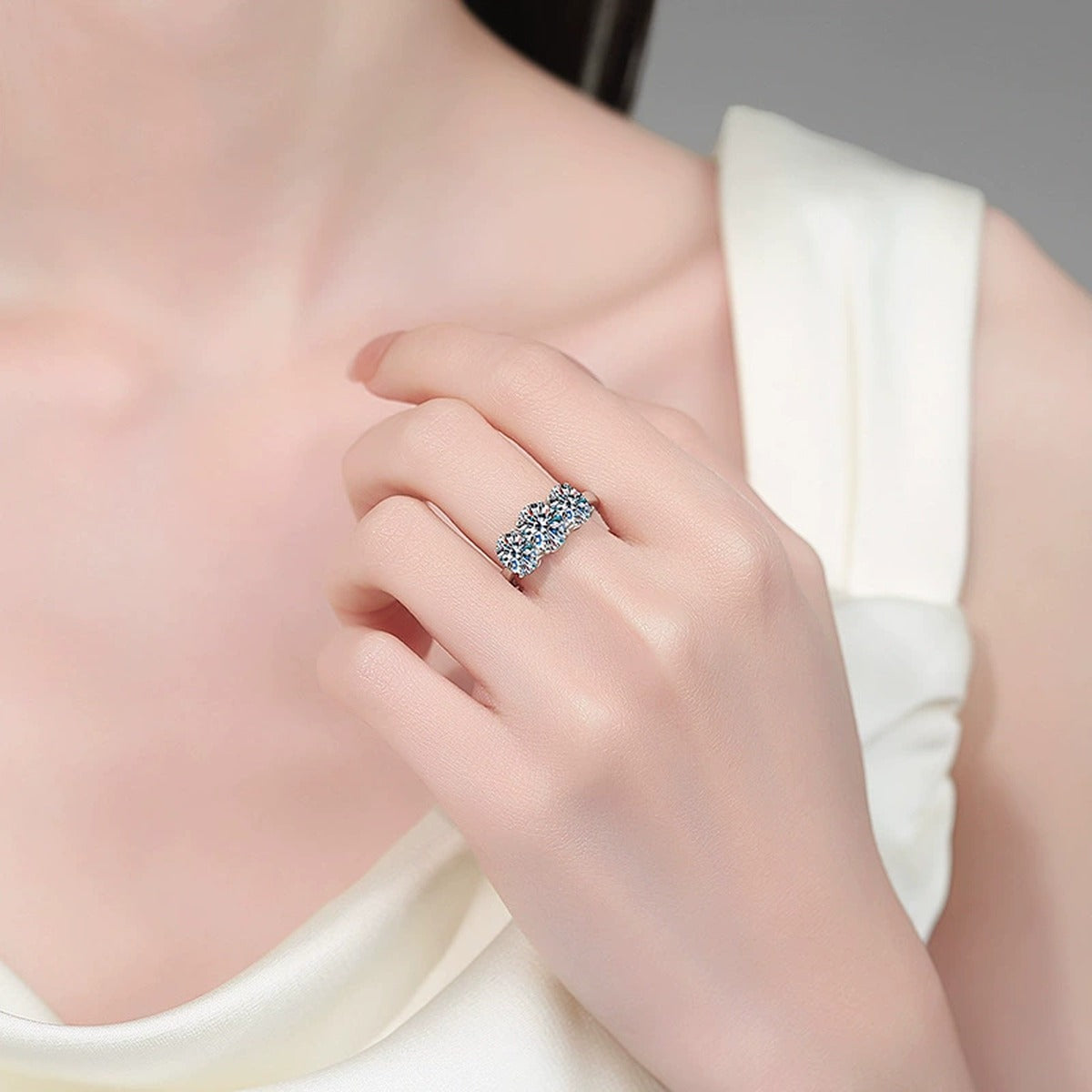 Oval Moissanite Three Stone Ring worn on hand to show scale, band width, and ring profile