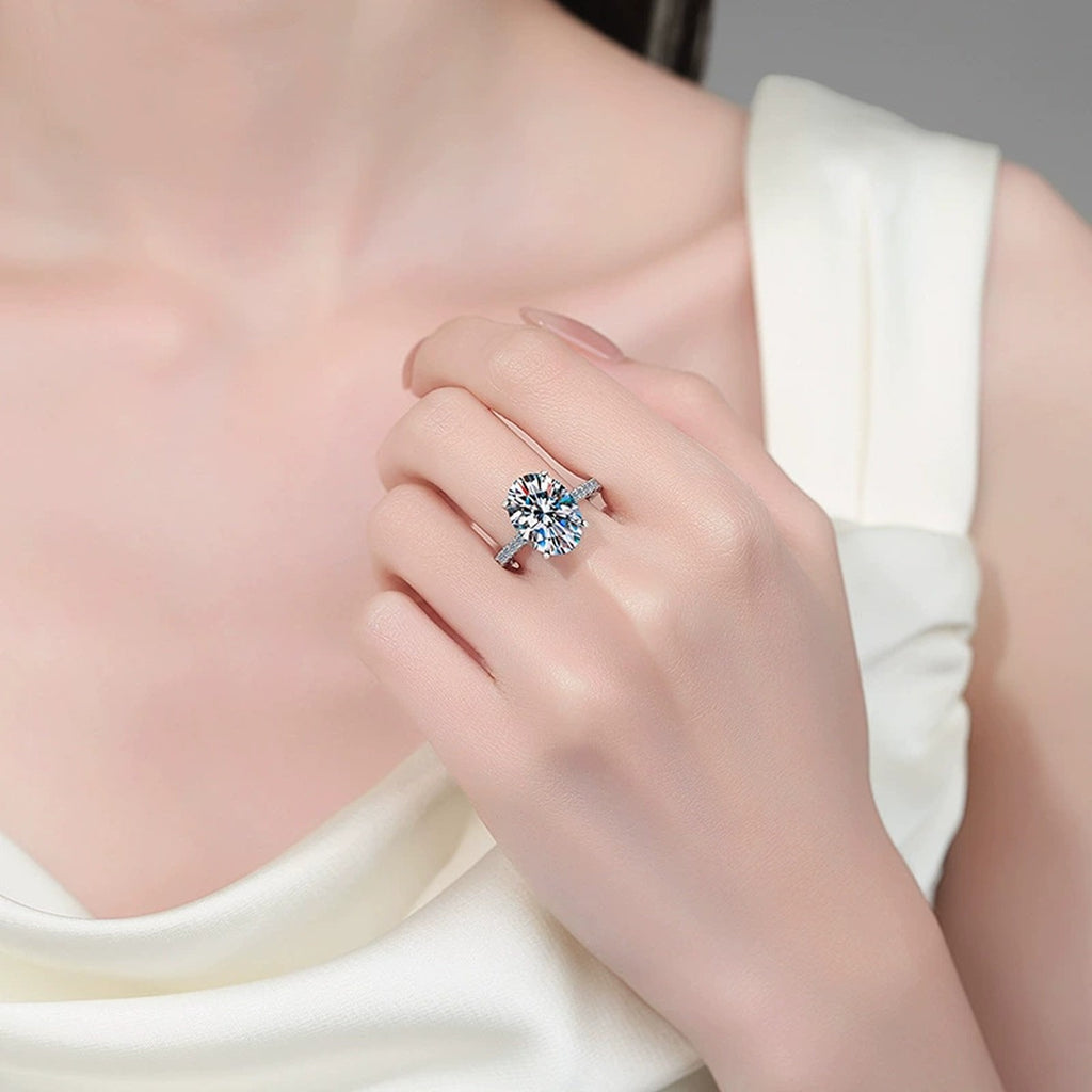 Oval Moissanite Engagement Ring with CZ worn on hand to show scale, band width, and ring profile