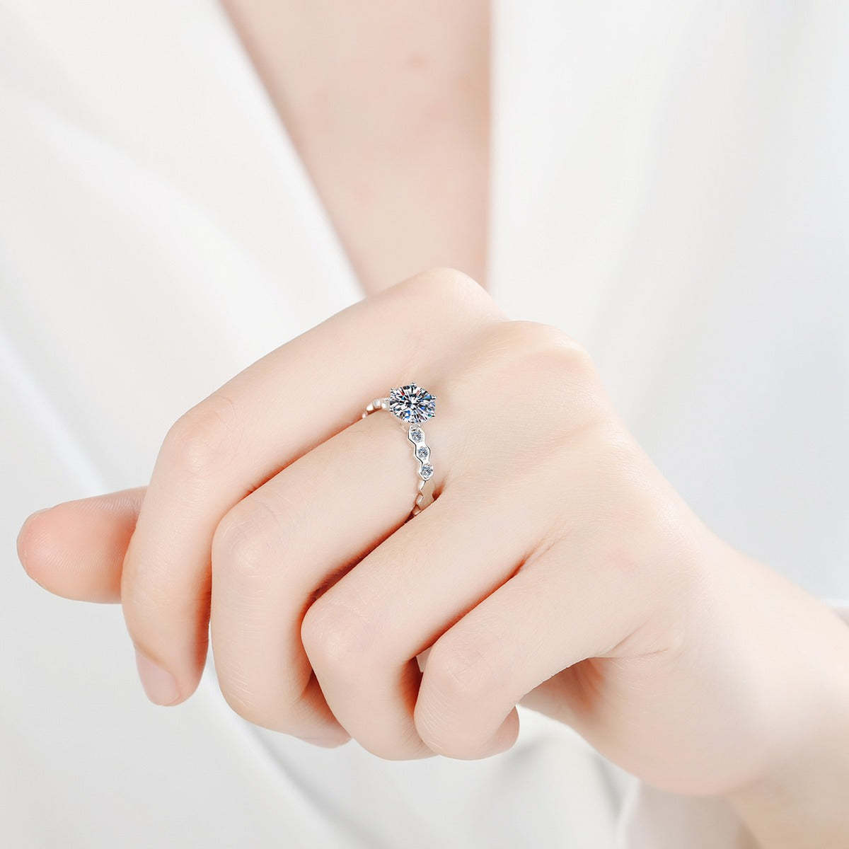 Round Moissanite Side Stone Ring with CZ worn on hand to show scale, band width, and ring profile