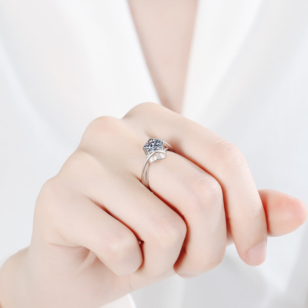 Round Moissanite Split Shank Engagement Ring worn on hand to show scale, band width, and ring profile