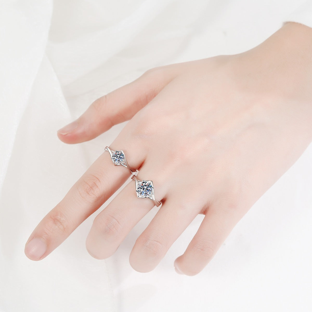 Round Moissanite Split Shank Engagement Ring worn on hand to show scale, band width, and ring profile