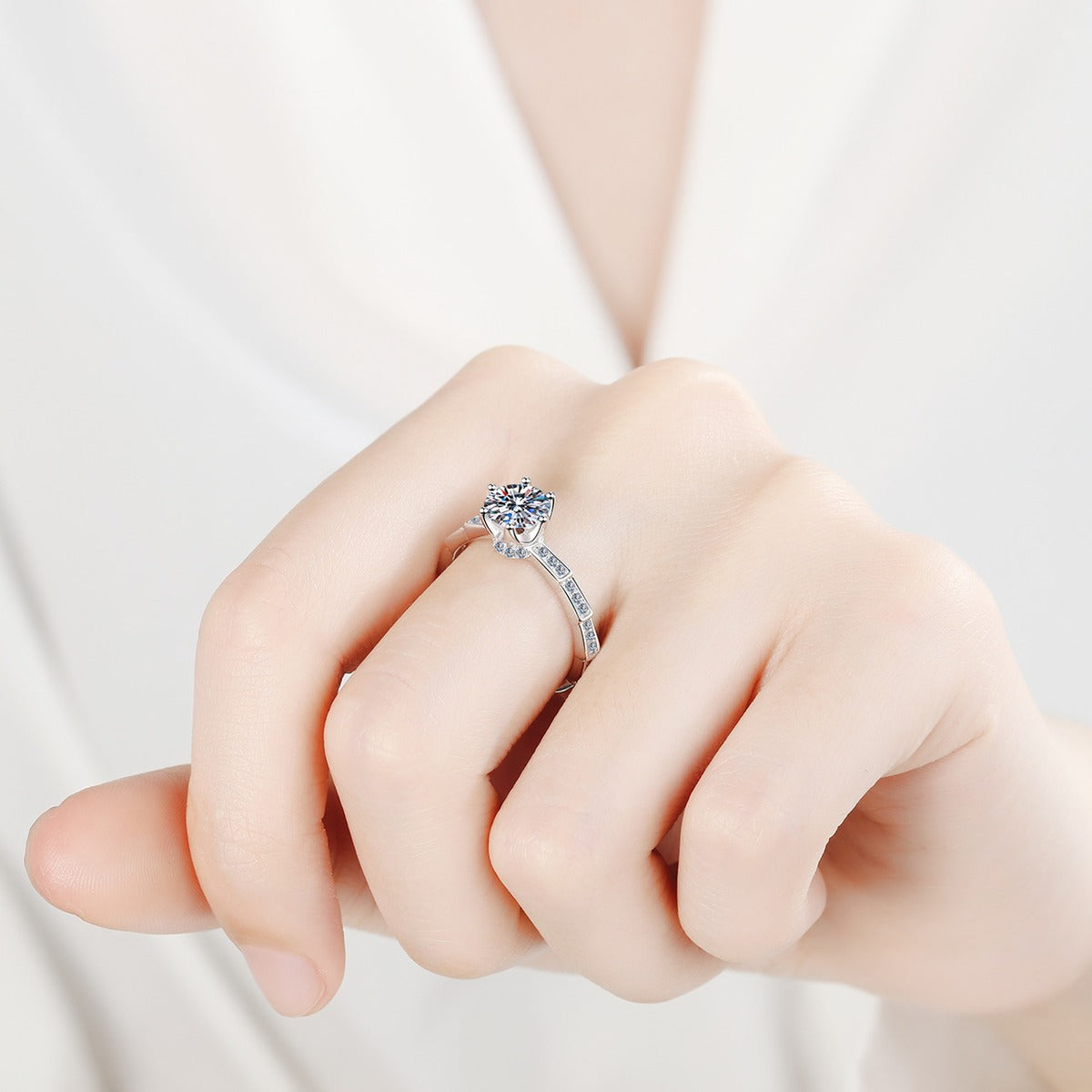 Round Moissanite Side Stone Ring with CZ worn on hand to show scale, band width, and ring profile