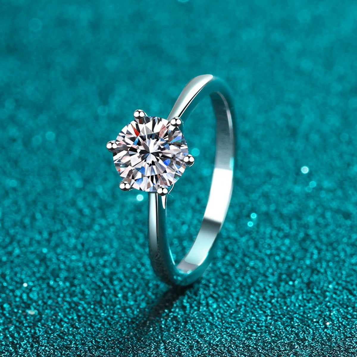 Round Moissanite Solitaire Ring in Rhodium-Plated S925 Sterling Silver blue display product photo showing the moissanite setting and band profile