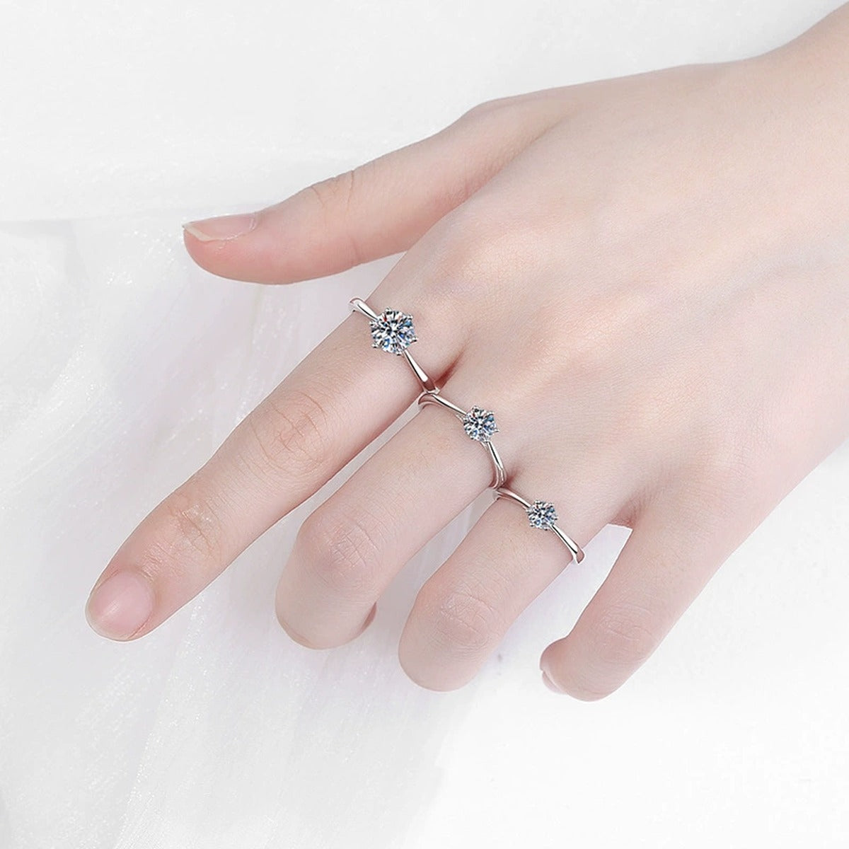 Round Moissanite Solitaire Ring in Rhodium-Plated S925 Sterling Silver worn on hand, showing scale, finger coverage, and rhodium-plated finish
