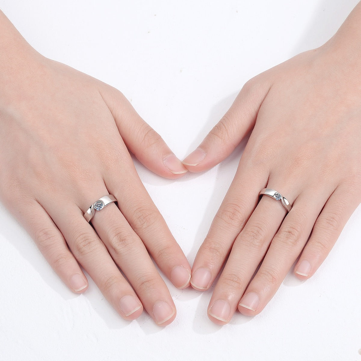 Round Moissanite Couples Ring Set worn on hand to show scale, band width, and ring profile