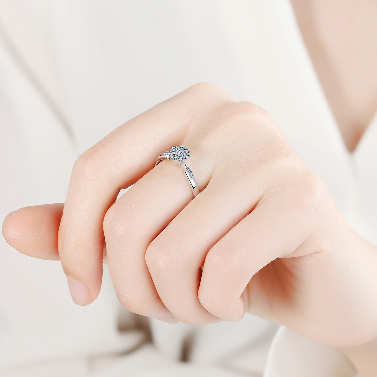 Round Cluster Moissanite Ring with CZ worn on hand to show scale, band width, and ring profile
