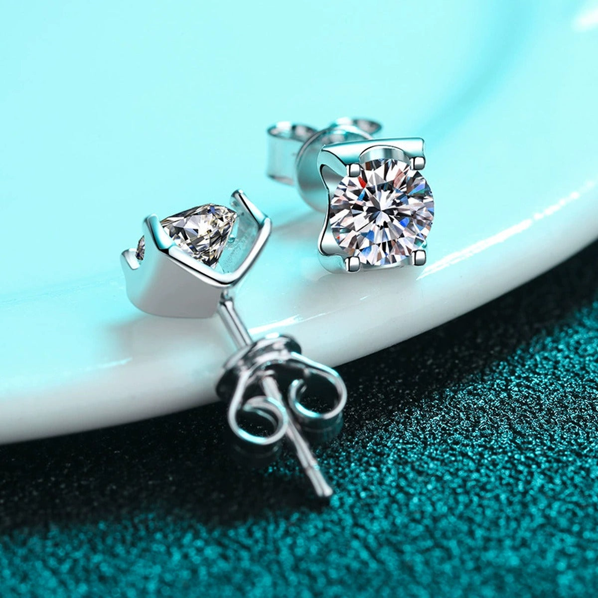 Square Moissanite Stud Earrings with CZ in Rhodium-Plated S925 Sterling Silver on blue-green fabric showing front detail