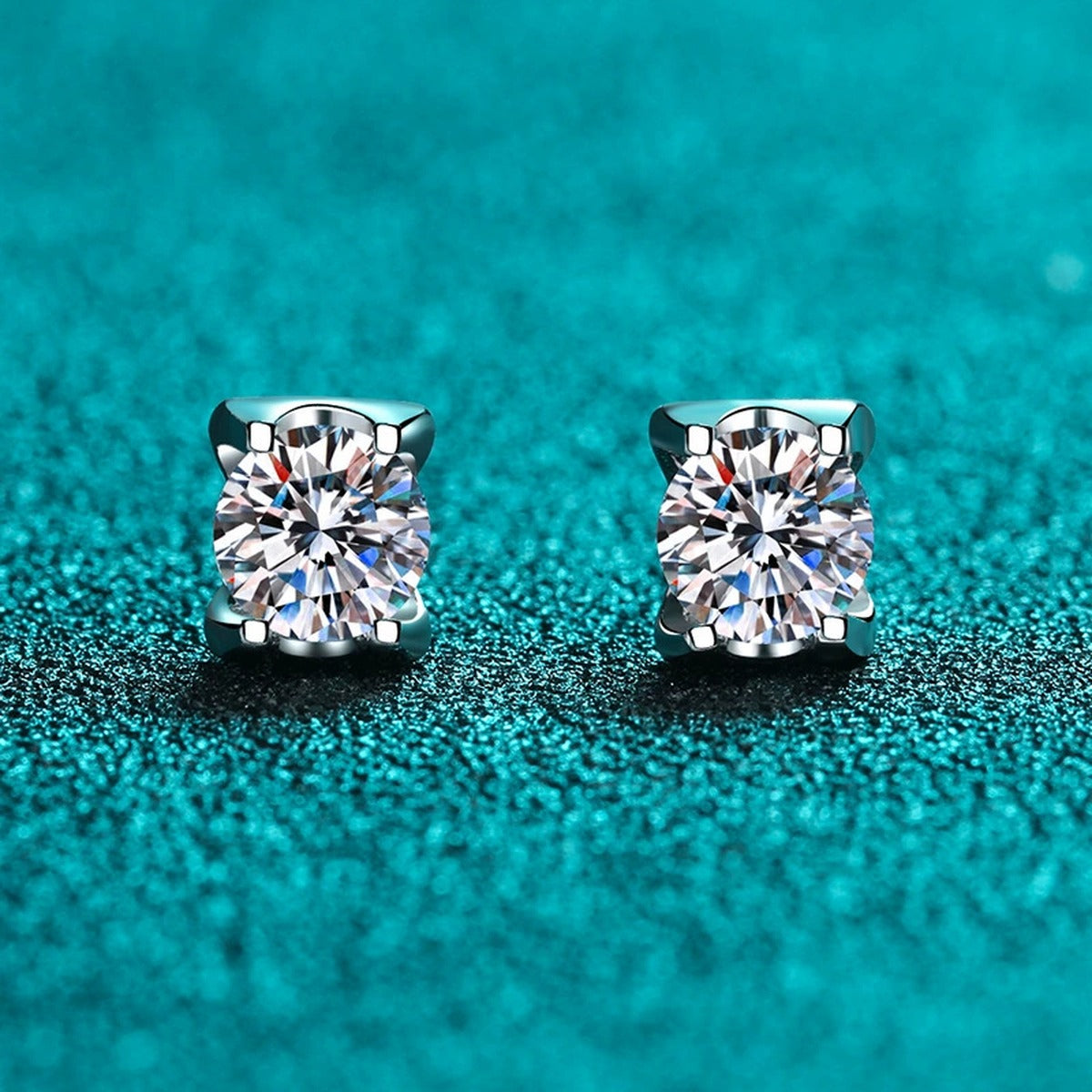 Square Moissanite Stud Earrings with CZ in Rhodium-Plated S925 Sterling Silver on blue-green fabric showing angled setting view