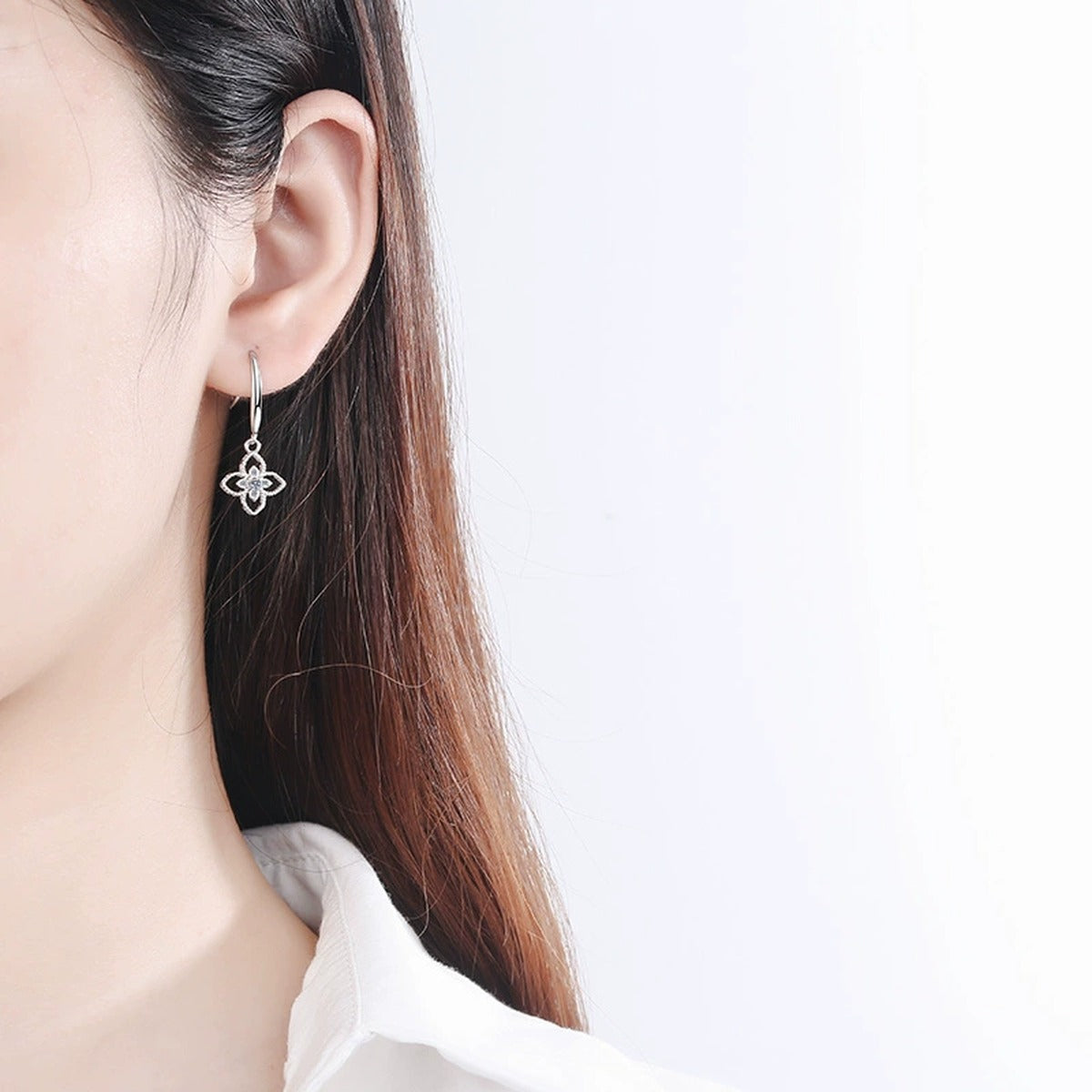 Floral Moissanite Hook Dangle Earrings in Rhodium-Plated S925 Sterling Silver worn on ear by model to show scale, drop length, and everyday styling
