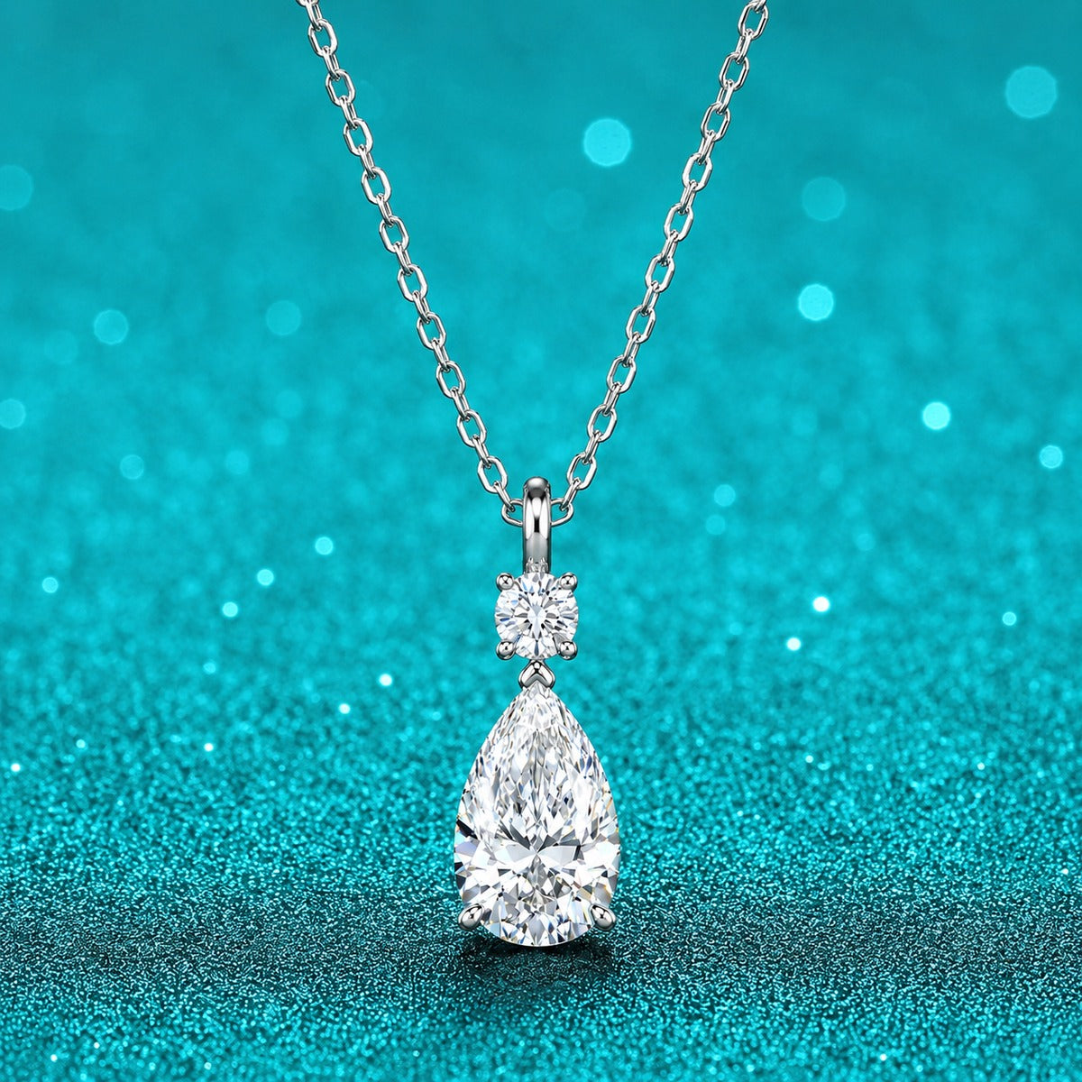 Pear and Round Moissanite Drop Necklace in Rhodium-Plated S925 sterling silver close-up product scene showing pendant setting