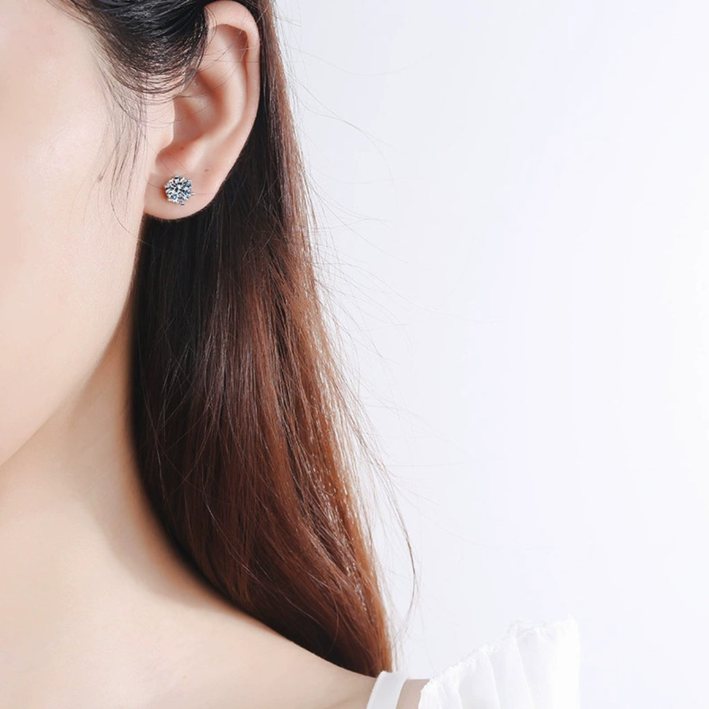 Classic Round Moissanite Stud Earrings in Rhodium-Plated S925 Sterling Silver worn on ear by model to show scale, drop length, and everyday styling