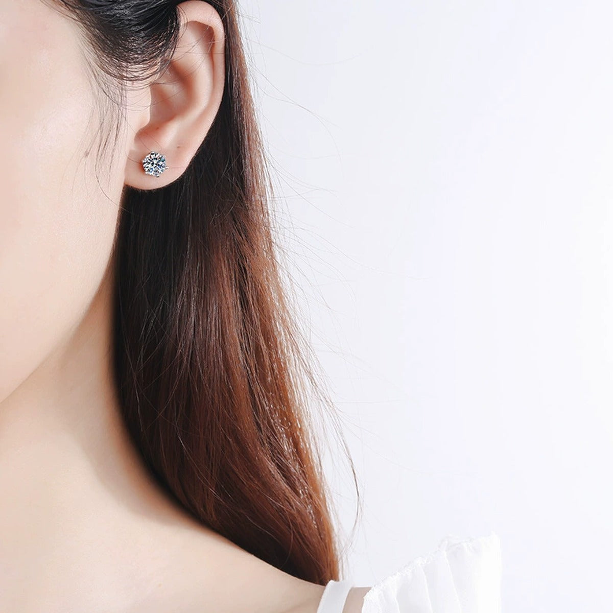 Classic Round Moissanite Stud Earrings in Rhodium-Plated S925 Sterling Silver worn on ear by model to show scale, drop length, and everyday styling