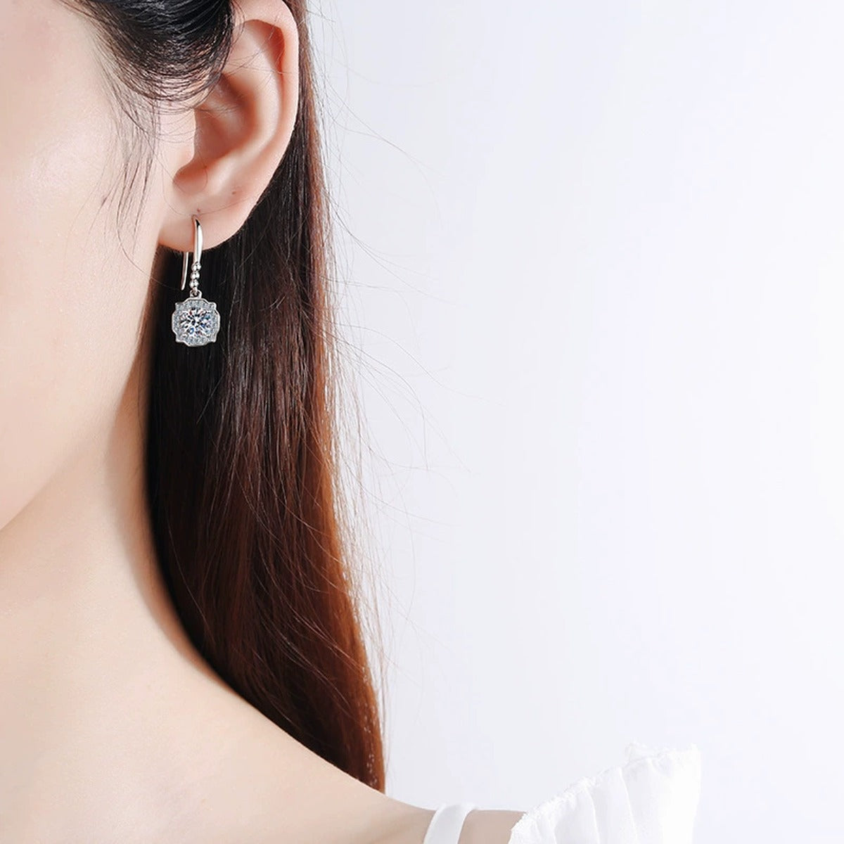 Round Halo Moissanite Hook Dangle Earrings with CZ in Rhodium-Plated S925 sterling silver worn on ear by model showing scale, placement, and hook dangle earrings styling
