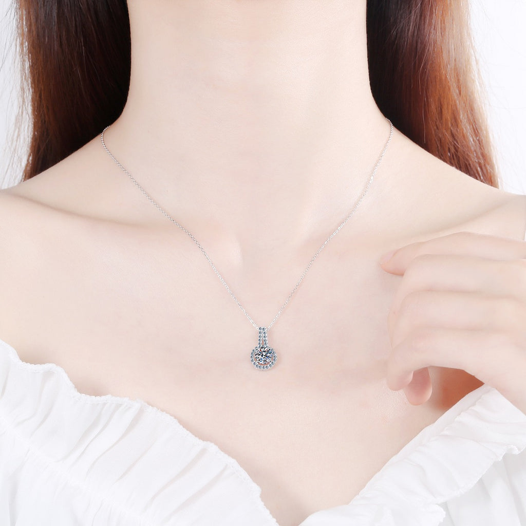 Halo Solitaire Moissanite Pendant Necklace with CZ in Rhodium-Plated S925 sterling silver worn on neckline by model showing scale and adjustable chain styling