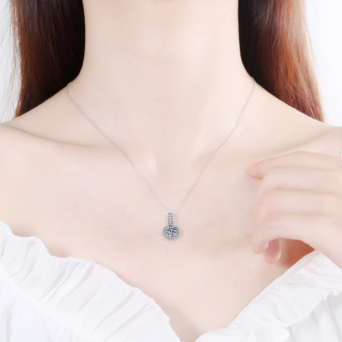 Halo Solitaire Moissanite Pendant Necklace with CZ in Rhodium-Plated S925 sterling silver worn on neckline by model showing scale and adjustable chain styling