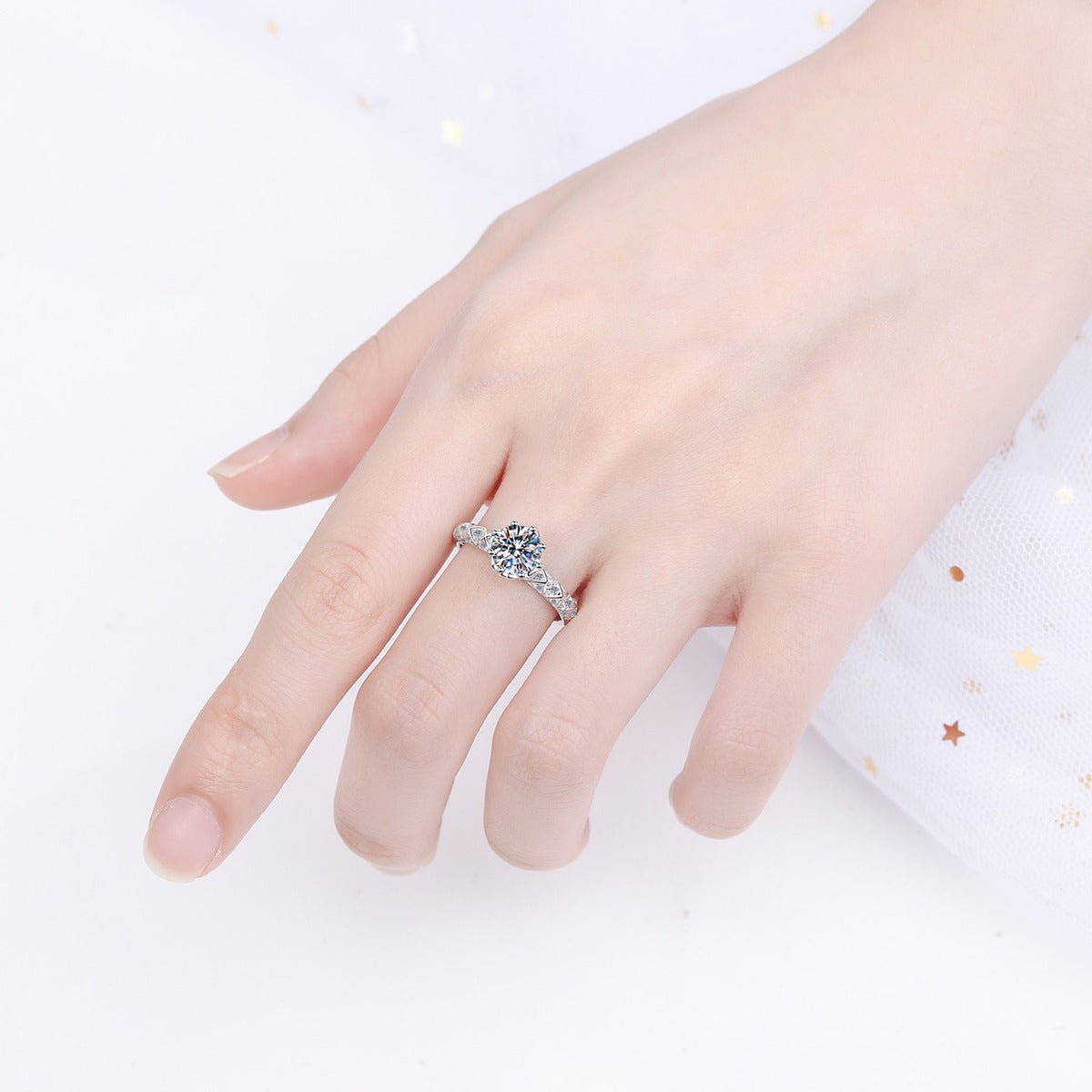 Round Moissanite Side Stone Engagement Ring with CZ worn on hand to show scale, band width, and ring profile