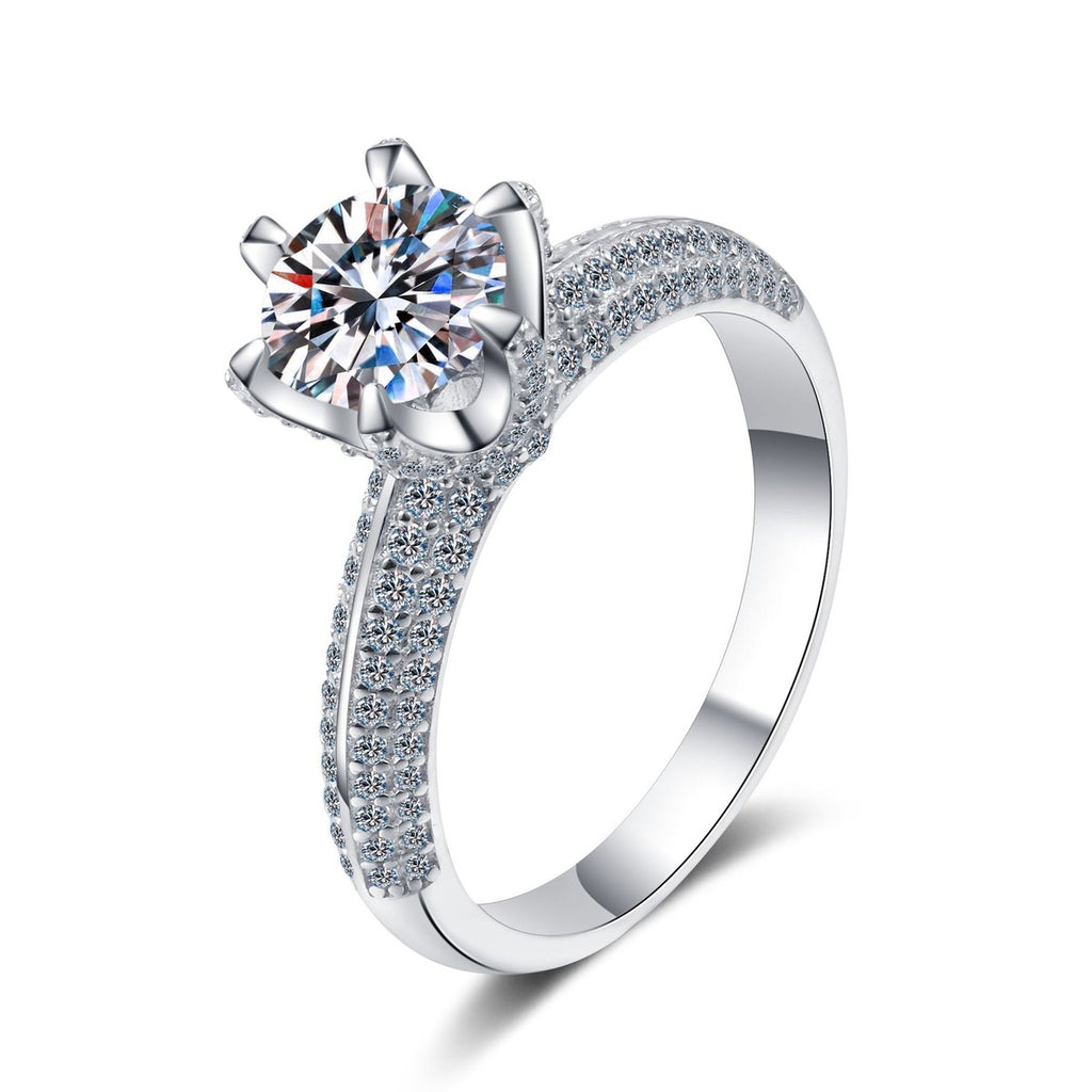 Round Moissanite Side Stone Ring with CZ in Rhodium-Plated S925 Sterling Silver clean white background product photo showing the ring silhouette and moissanite setting