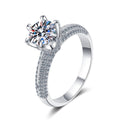Round Moissanite Side Stone Ring with CZ in Rhodium-Plated S925 Sterling Silver clean white background product photo showing the ring silhouette and moissanite setting