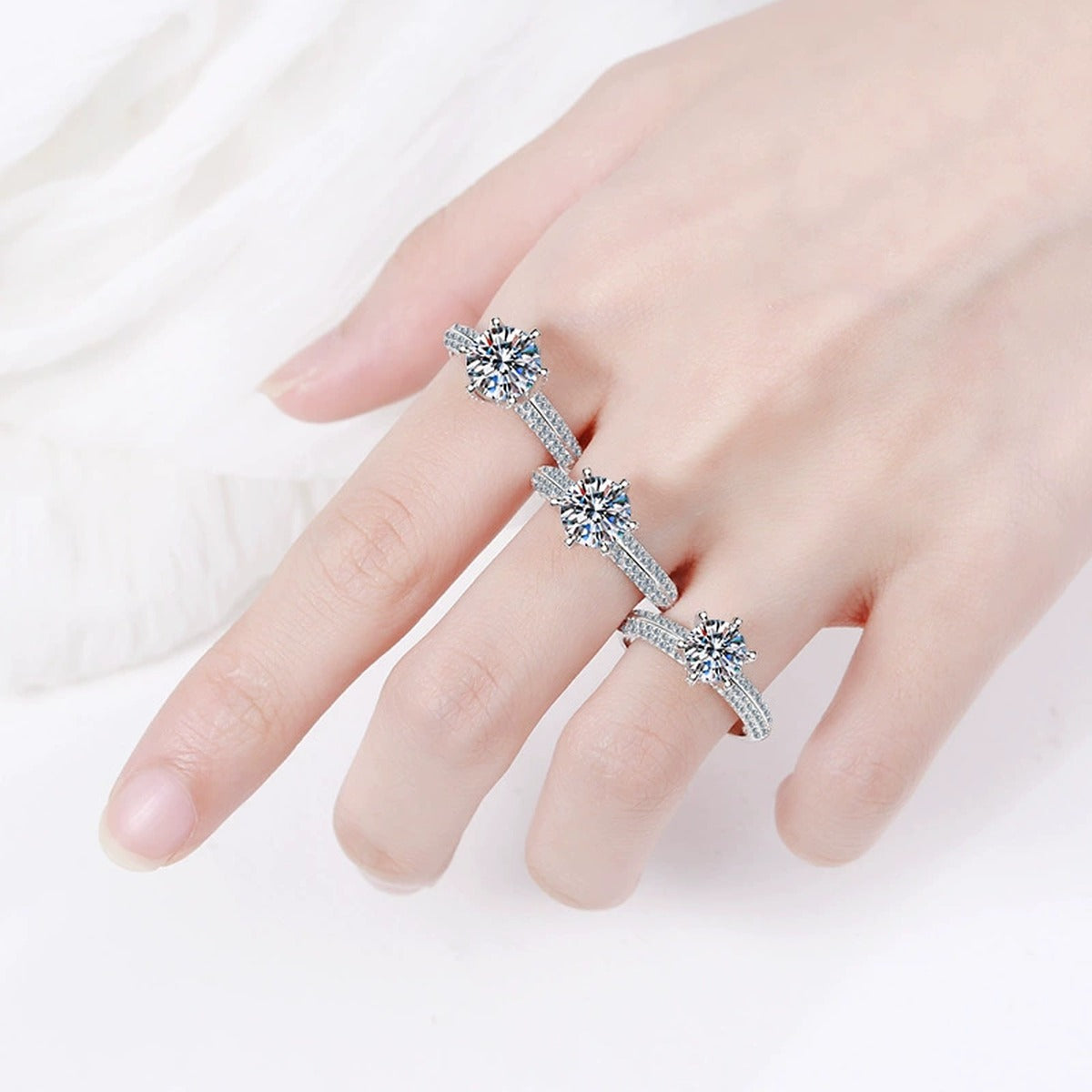 Round Moissanite Side Stone Ring with CZ in Rhodium-Plated S925 Sterling Silver worn on hand, showing scale, finger coverage, and rhodium-plated finish