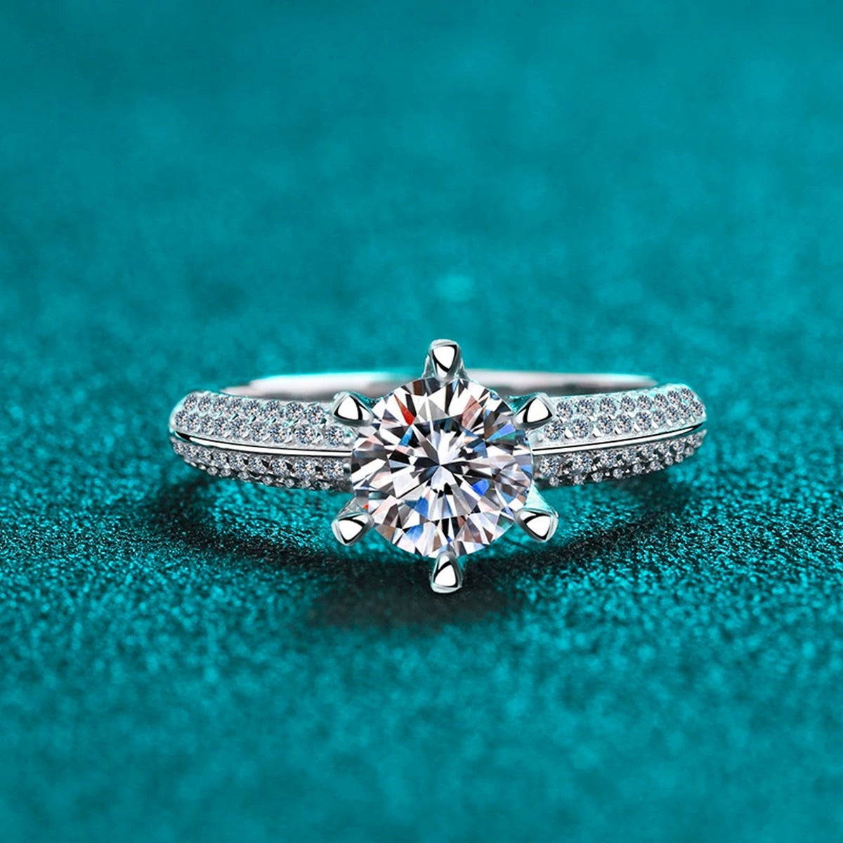 Round Moissanite Side Stone Ring with CZ in Rhodium-Plated S925 Sterling Silver blue display product photo showing the moissanite setting and band profile