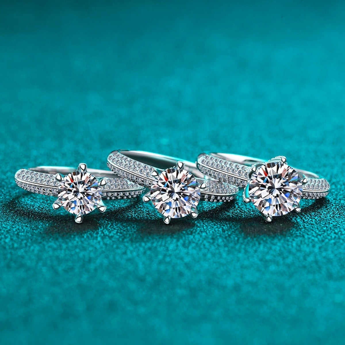 Round Moissanite Side Stone Ring with CZ in Rhodium-Plated S925 Sterling Silver blue display product photo showing the moissanite setting and band profile