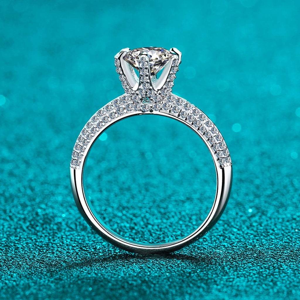 Round Moissanite Side Stone Ring with CZ in Rhodium-Plated S925 Sterling Silver blue display product photo showing the moissanite setting and band profile